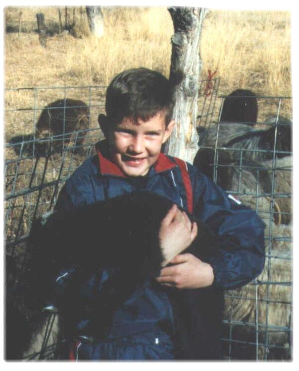 K . holding baby lamb Patricio